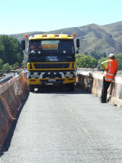 Dave Ballantyne drives a truck on to the northern bridge on SH82 over the Waitaki River, guided...