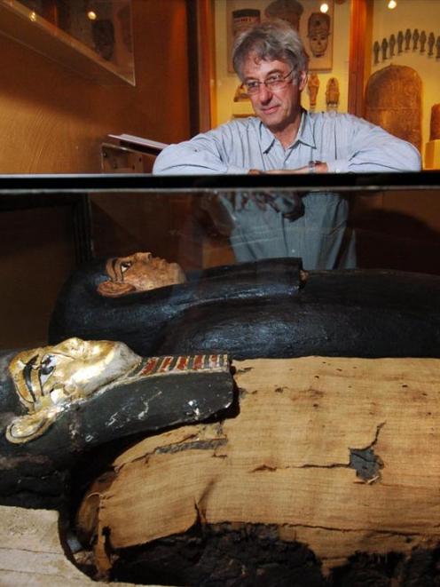 Dave Wright, the Otago Museum's collections, assets and research director, examines an Egyptian...