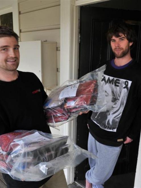 David Booth (left) delivers the flat meat to Cameron McQueen (21), a  third-year physical...