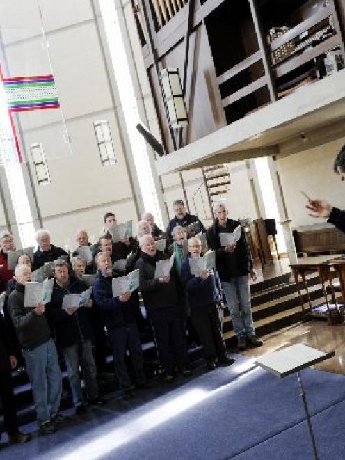 David Burchell rehearses the male singers of the City of Dunedin choir in 'Four Little Prayers of...