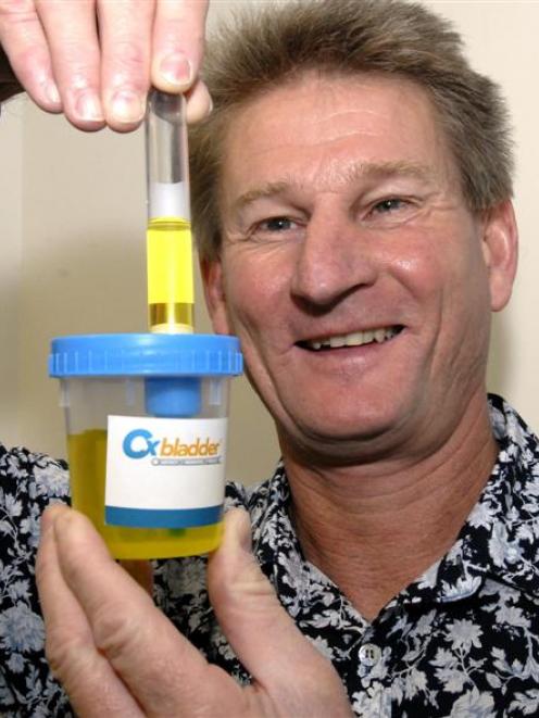 David Darling demonstrates one of the  Pacific Edge bladder cancer testing kits. Photo by Gregor...