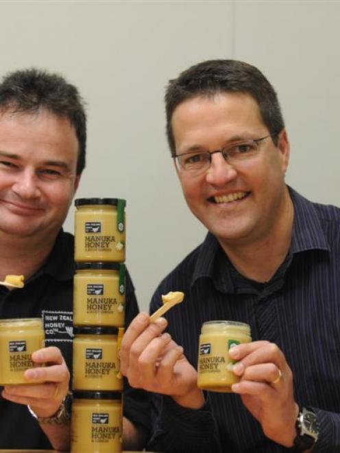 David McMillan (left) and Peter Cox, of the New Zealand Honey Company, sample  its new products....