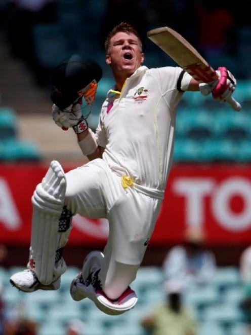 David Warner celebrates reaching his century against India. REUTERS/David Gray