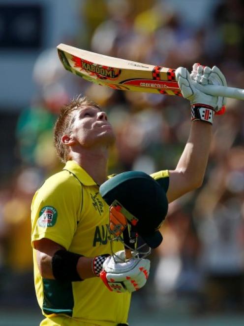 David Warner celebrates reaching his century against Afghanistan in Perth. REUTERS/David Gray