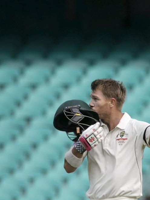 David Warner kisses his helmet after scoring a century against the West Indies on the final day...