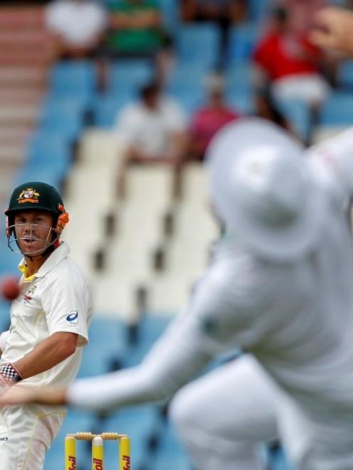 David Warner (L) watches as South Africa captain Graeme Smith tries to make a catch. REUTERS...