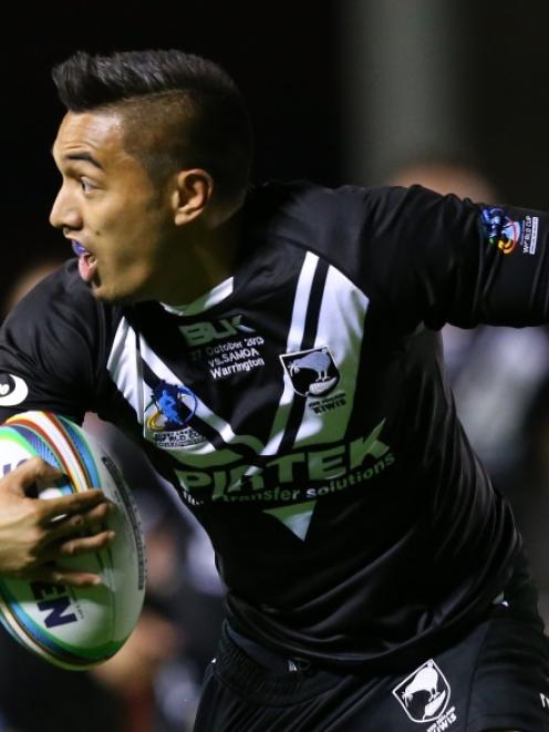 Dean Whare of New Zealand is tackled by Anthony Milford of Samoa during the Rugby League World...
