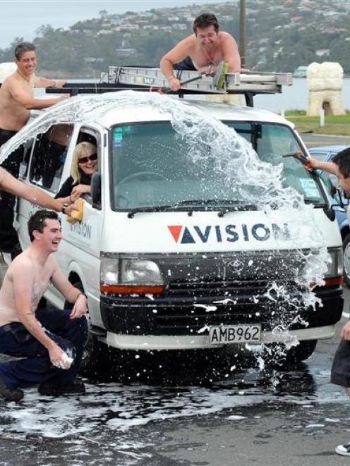 Deanna Hoskins enjoys a car wash from the men of audiovisual company Vision and their contractors...
