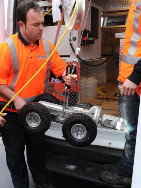 Delta CCTV operator Matt Peoples prepares to lower the company's new pipe inspection camera into...