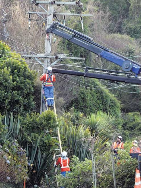 Delta staff work to replace an old wooden power pole with a concrete one, near Jessie St, Maia,...