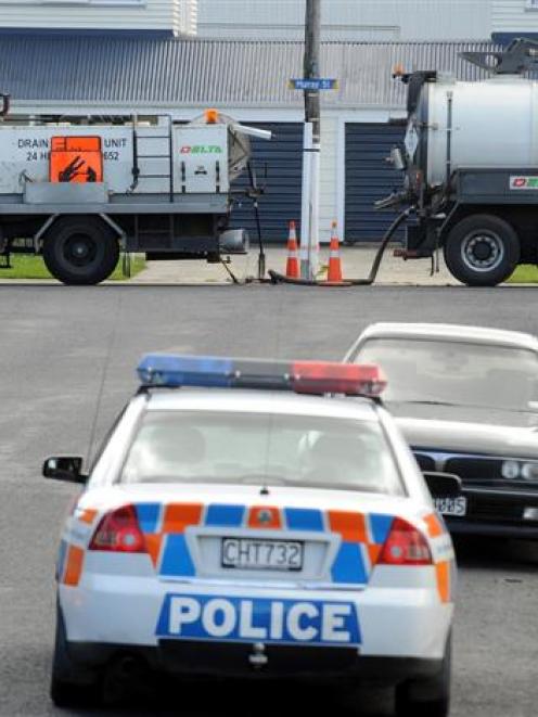 Delta trucks stay where they stopped after a grenade was discovered by workers cleaning a sewer...