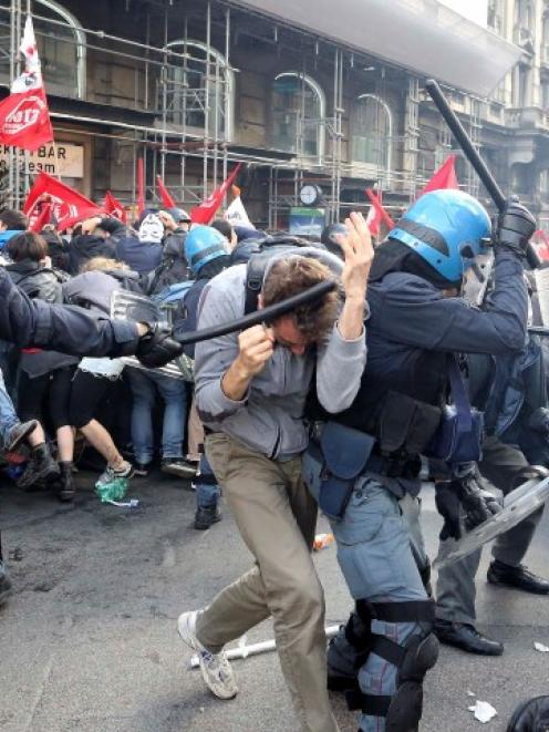 Demonstrators clash with policemen during a protest against austerity measures in downtown Rome....