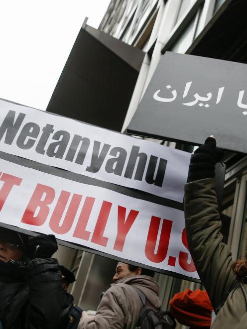 Demonstrators hold signs during a rally near the Israeli Consulate in New York. Photo by Reuters.