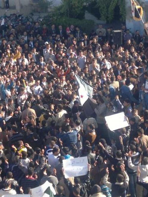 Demonstrators protest against Syria's President Bashar al-Assad after Friday prayers in Homs....