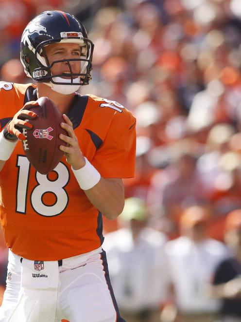 Denver Broncos quarterback Peyton Manning (18) drops back to throw his 500th career touchdown...