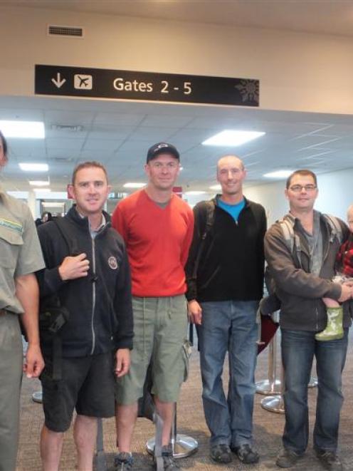 Department of Conservation firefighters leaving Queenstown yesterday for Melbourne, to help fight...