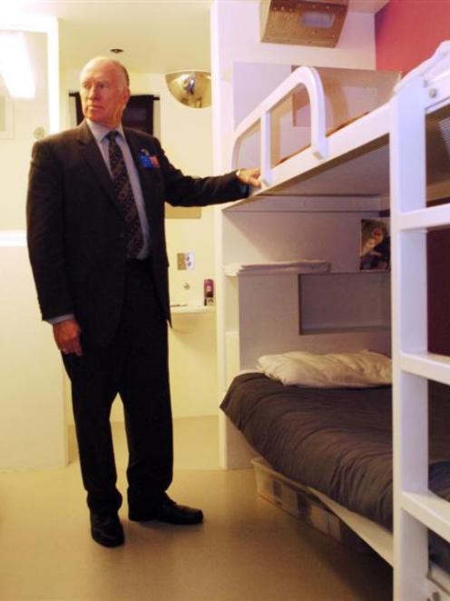Department of Corrections chief executive Barry Matthews inspects a newly fitted double-bunked...