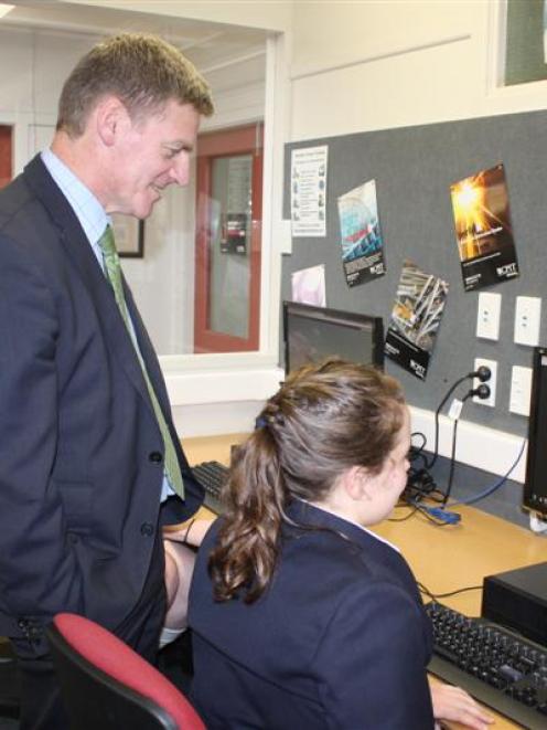 Deputy Prime Minister Bill English watches as year 10 pupil Shnece  Duncan accesses an internet...