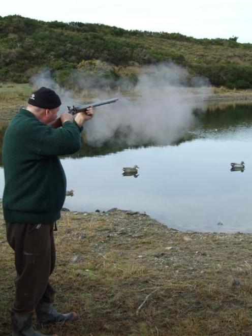 Derek Barrett (above and at right) gives his 140-year-old gun an airing during duck-shooting....