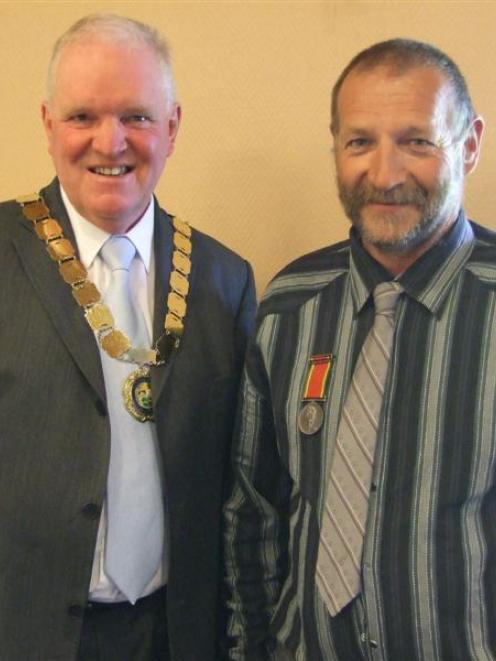 Des Harborne (right), who was presented with his Humane Society medal by Mayor Malcolm Macpherson...
