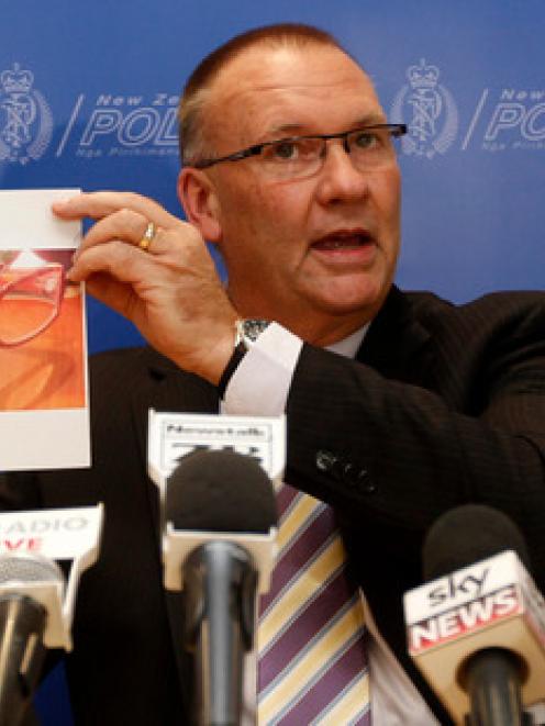 Detective Senior Sergeant Stan Brown holding a picture of glasses believed to be in the...