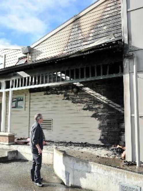 Detective Sergeant Brett Roberts examines the fire-damaged King's High School gymnasium, on...