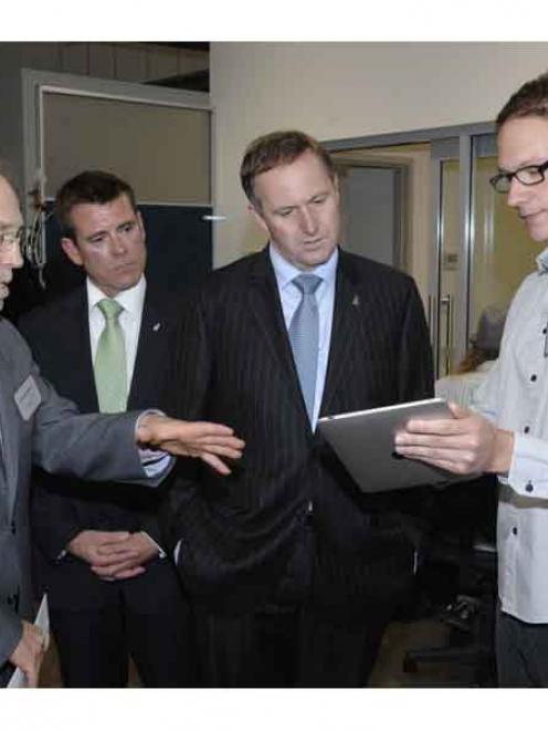 Developer Tim Nixon (right) demonstrates the new Flutter game on Facebook to Prime Minister John...