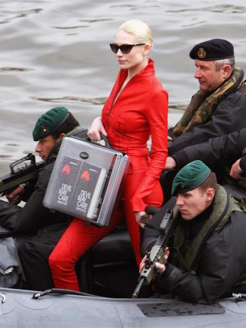 Model Tuuli Shipster holds a case containing the first seven copies of writer Sebastian Faulks'...