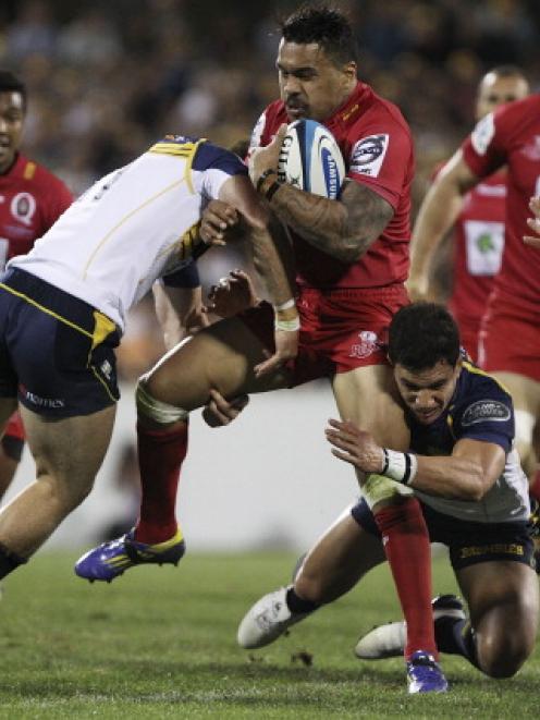 Digby Ioane of the Reds is tackled during the round 1 Super Rugby match between the Brumbies and...