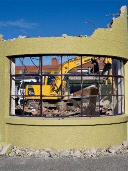 Digger operator Robert Hazlett works on the demolition of the Ranfurly Auto building in Ranfurly...
