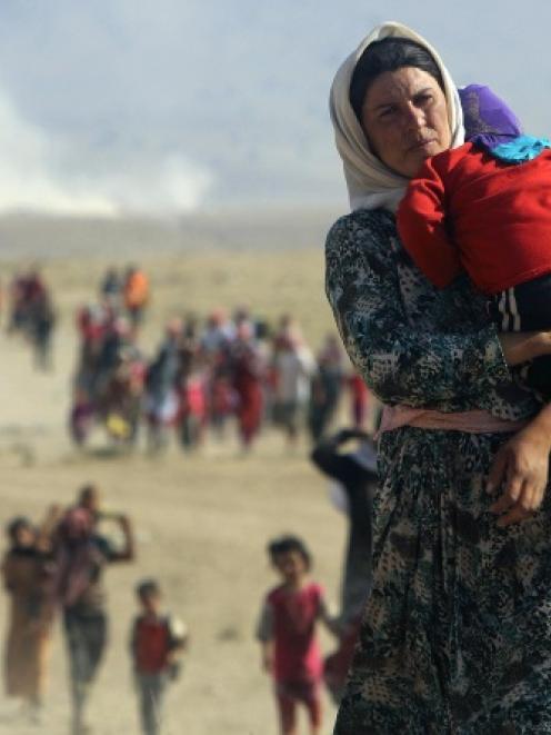 Displaced people from the minority Yazidi sect, fleeing violence from forces loyal to the Islamic...