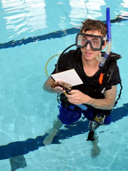 Diver Abe Kemp takes a break while replacing cracked and broken tiles in the Dunedin Hospital...