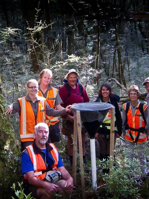 Doc staff and volunteer members of the Matukituki Charitable Trust with one of the eight funnels...