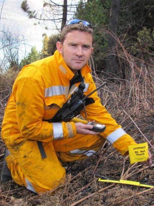 Doc Wakatipu fire investigator Jaime Cowan holds a GPS on Wednesday to way point a piece of...