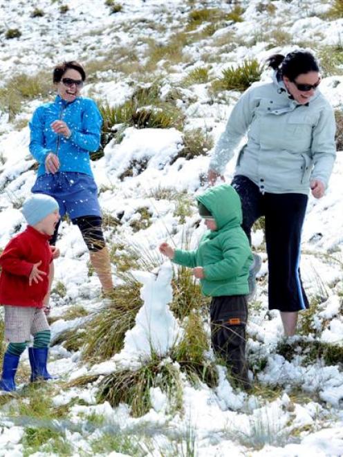 Dodging snowballs on the Crown Range yesterday are Rachel Shirley (left) and her son Ethan...