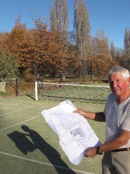 Don Kindley, of Albert Town,  looks over plans for his property where confusion over boundaries...