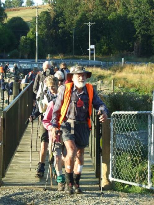 Don Morrison leads the Otago Goldfields Cavalcade 'Whisky Galore' walking trail on to the...