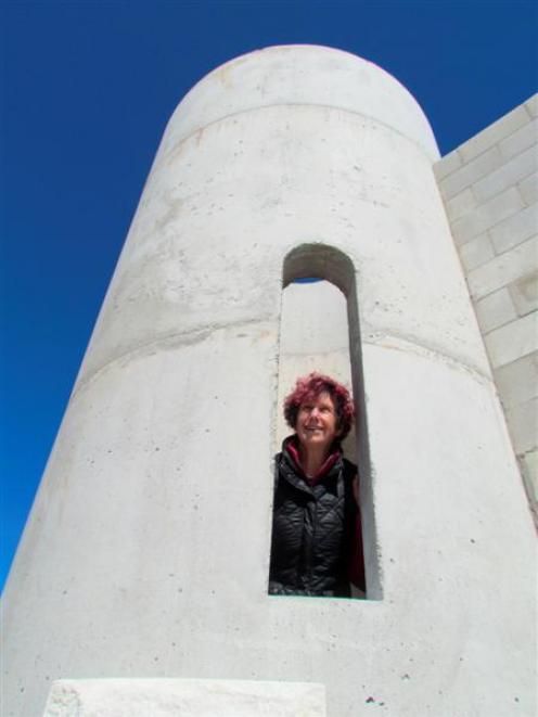 Dot Smith peeks out of her Oamaru stone castle, being built at Hilderthorpe, near Oamaru. Photo...