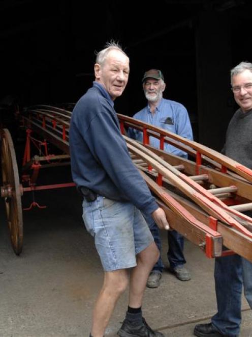 Doug Hall (right, rear), the owner of Hall Brothers Transport Ltd, helps Dunedin Fire Brigade...