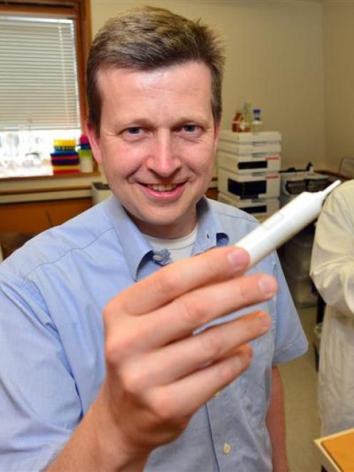 Dr Olaf Bork (front) works on mastitis research in the laboratory at the University of Otago's...