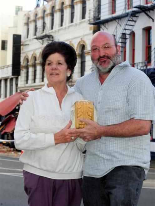Dragon Cafe waitress Lyn Kennedy holds a piece of the parapet that crashed down around her ...