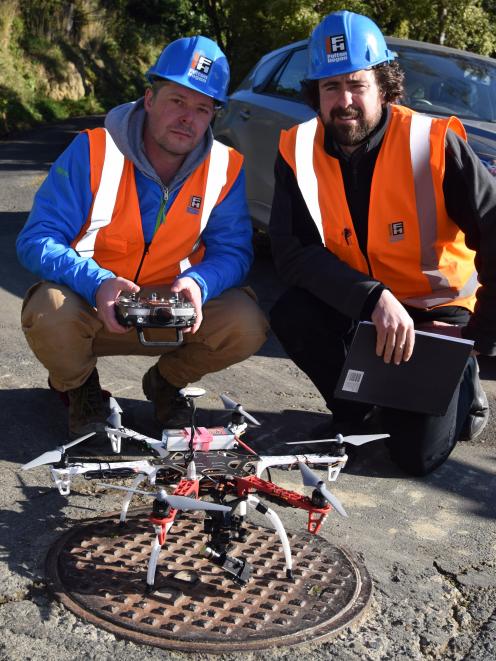 Drone pilot Aaron McGrouther (left) and Fulton Hogan laboratory manager Dr Sean Connaughton with...