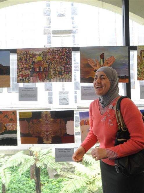 Dunedin Abrahamic Interfaith Group secretary Mai Tamimi  previews   paintings created by...