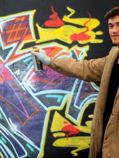 Dunedin artist Shem Fitiao works on 'Graf the Box' in the Octagon yesterday.  Underground artists...