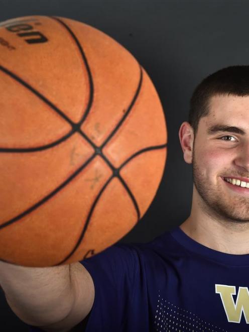 Dunedin basketballer Sam Timmins sports his new University of Washington shirt as he contemplates...