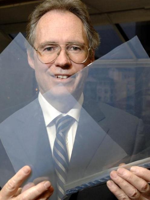 Dunedin City Council chief executive Jim Harland peers through samples of the ETFE roof cladding...