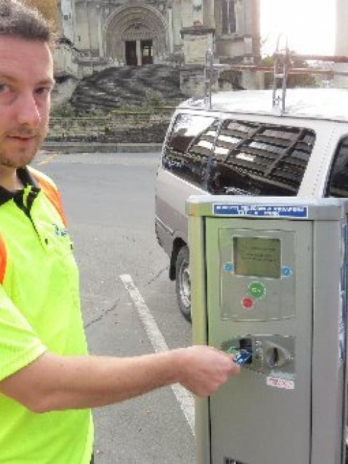 Dunedin City Council parking meter technician Reece Smith  checks the credit card-reader in a...