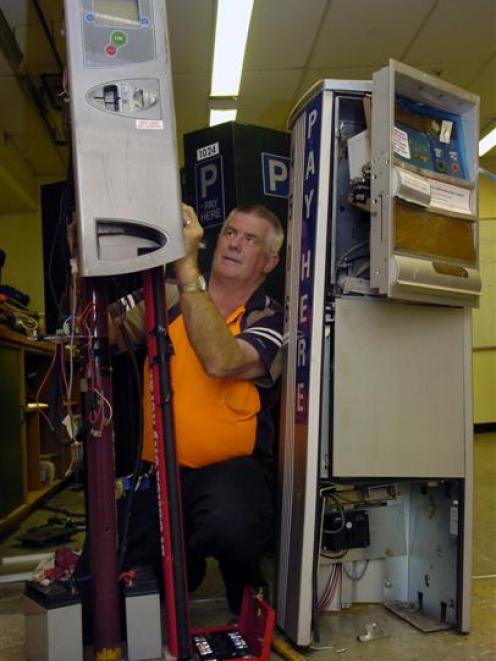 Dunedin City Council parking technician Alex Shand with parking machines damaged by vandals....