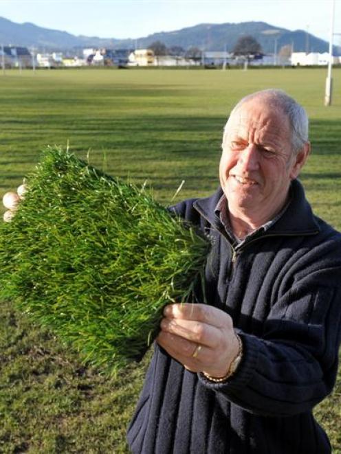 Dunedin City Council sports fields facilities officer Harold Driver displays a sample of...