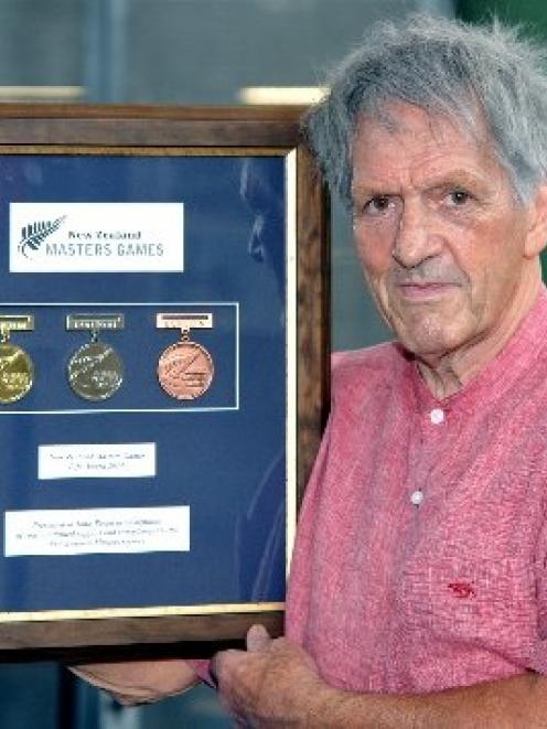 Dunedin City Councillor John Bezett holds his New Zealand Masters Games Life Award at the Games...